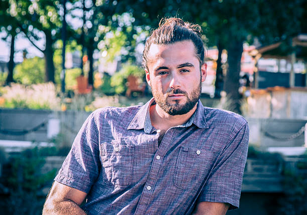 istock Young Man with Hair Bun and Beard 609080410