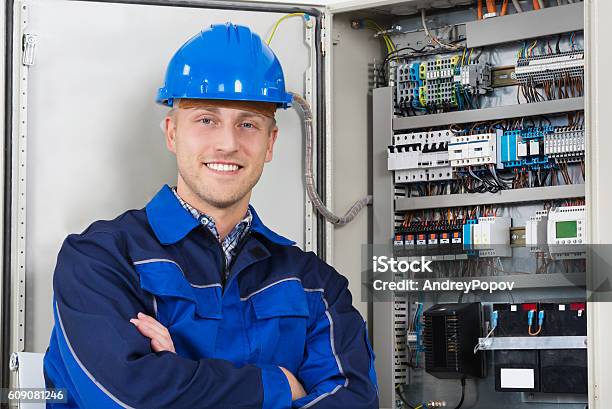 Portrait Of A Happy Young Male Electrician Stock Photo - Download Image Now - Electrician, Happiness, Fuse Box