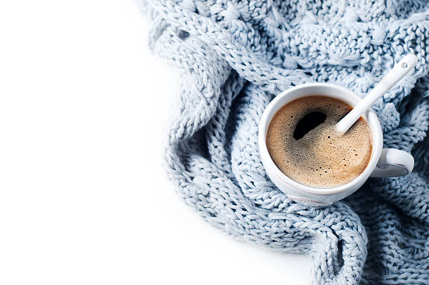 istock Cup of coffee and knitted sweater on the white table 609081452
