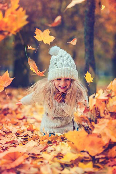 istock Little girl in autumn park 609082424