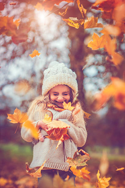 istock Little girl in autumn park 609082616