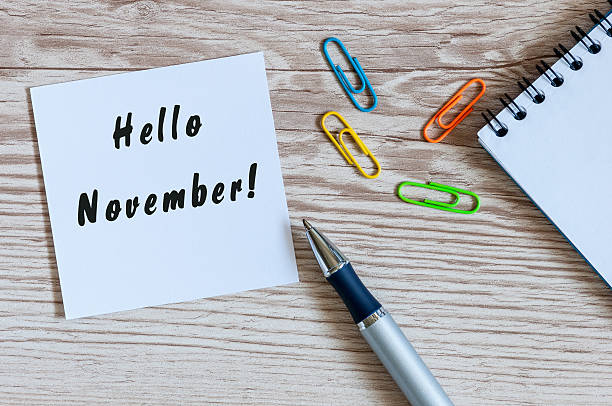 istock Hello November. hand drawn lettering on notepad at the workplace 609083256