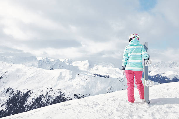 istock Young woman with snowboard 609083338