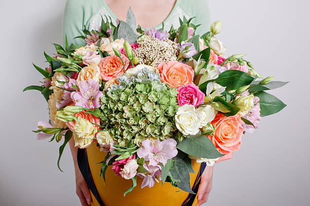 istock rich bouquet with hydrangea in woman hand . colorful roses and 609084228
