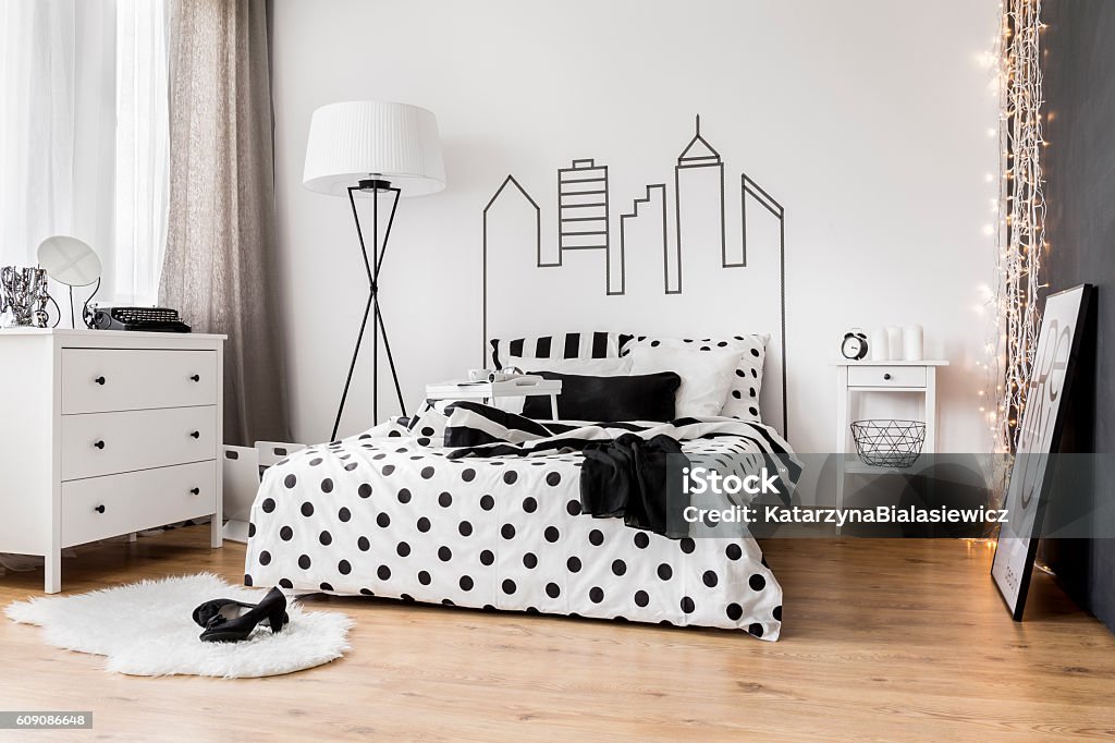 Morning mess in woman's bedroom Bright bedroom interior with wide bed, commode and bedside cabinet Bedroom Stock Photo