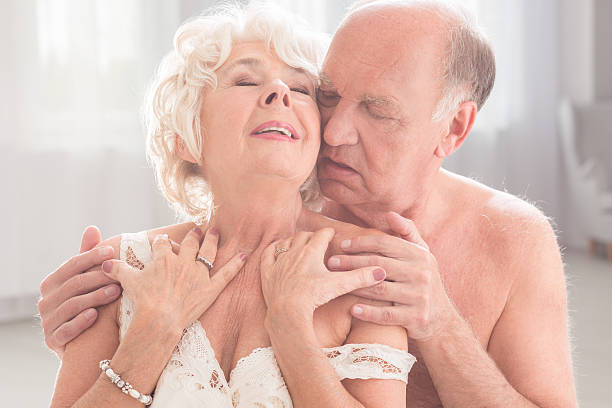 Embrace of love Shot of a naked senior man holding his wife in a passionate embrace sex senior couples stock pictures, royalty-free photos & images