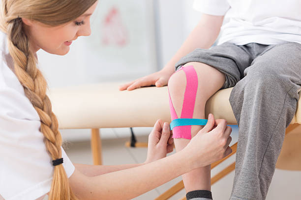 istock Kinesio taping therapy after knee injury 609087834
