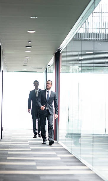 istock japanese Businessmen walking on the office corridor 609089742