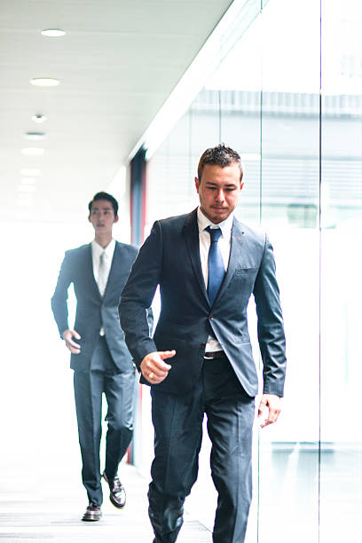 istock japanese Businessmen walking on the office corridor 609089924