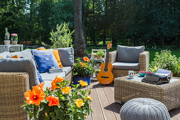 Luxurious villa patio with rattan sofa, armchair and small table