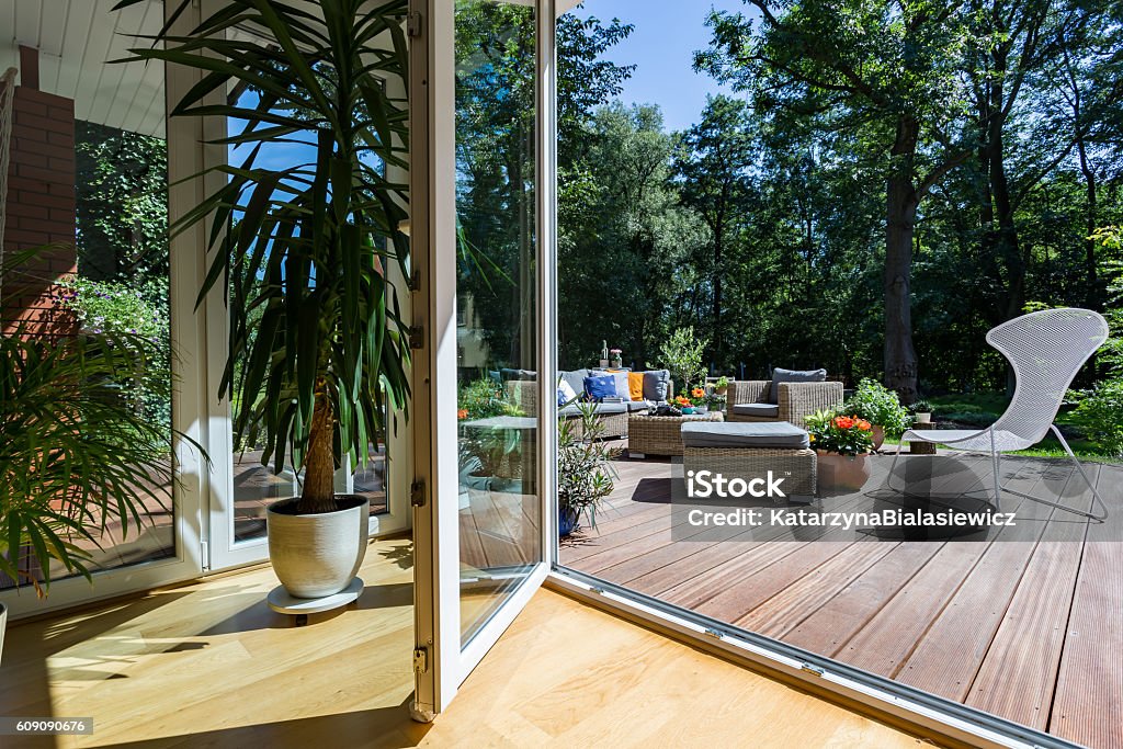 Doors open to relax Open terrace doors, in the background outdoor furniture set Balcony Stock Photo