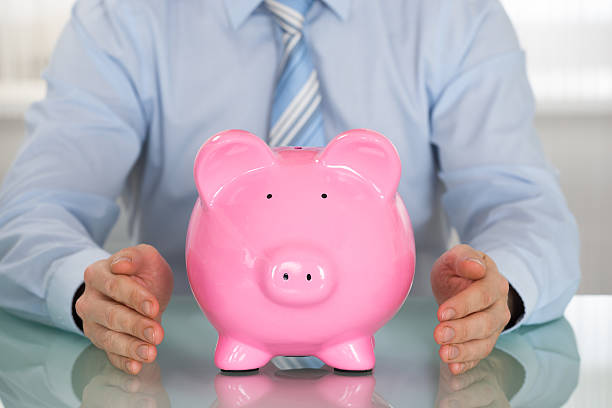 istock Businessman Hand Protecting Piggy Bank 609091604