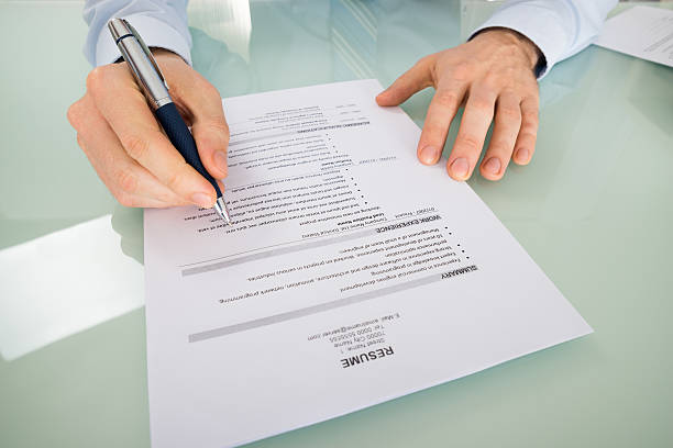 istock Businessperson With Resume At Desk 609091886