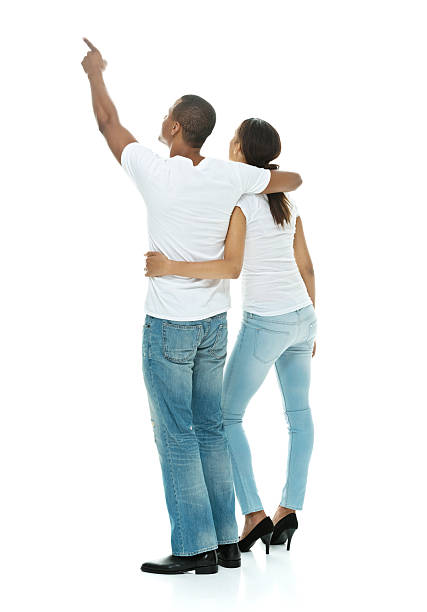 istock Rear view of couple pointing away 609093174
