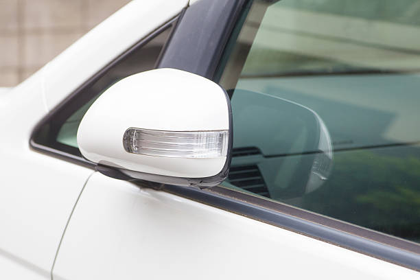 istock Side rear-view mirror closed for safety at car park. 609095816