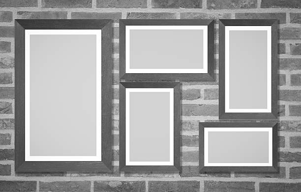 istock Wooden picture frame on brick wall background 609095964