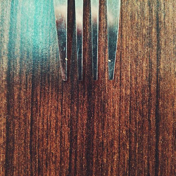 High Angle View Of Fork On Wooden Table