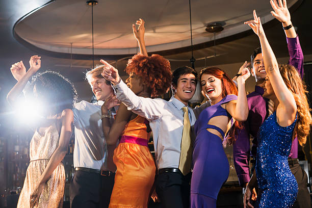 istock Multi-ethnic group of young adults dancing at club 609410012