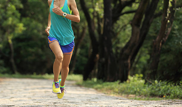 istock young woman trail runner running at forest stone trail 609427902