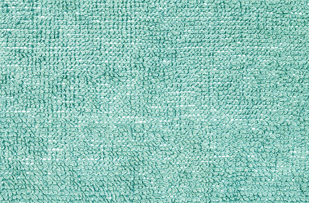 istock Closeup green fabric mat texture background 609428572