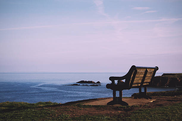 istock Empty bench over looking the coast in Bude, Cornwall Vintage 609441484