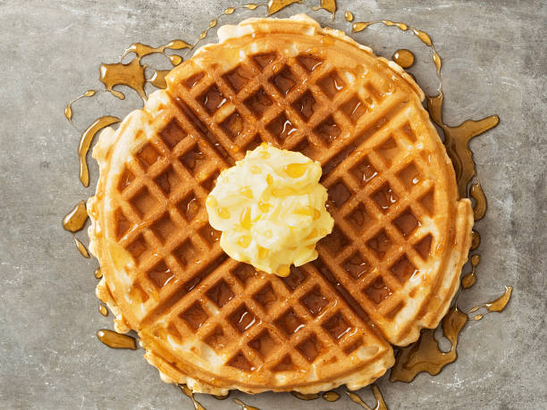 istock rustic traditional waffle with butter and maple syrup 609442738