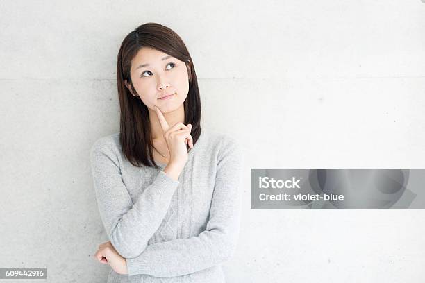 Thinking Young Woman Stock Photo - Download Image Now - Question Mark, Women, Japanese Ethnicity