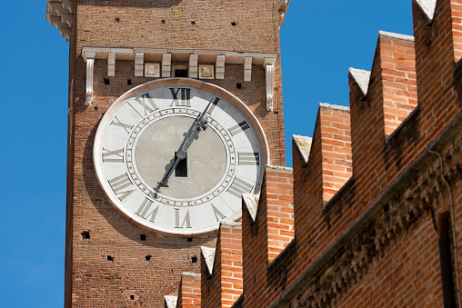 Detail of medieval clock tower of Lamberti (Torre dei Lamberti) (XI century - 84 m.) in Verona (UNESCO world heritage site) - Veneto, Italy