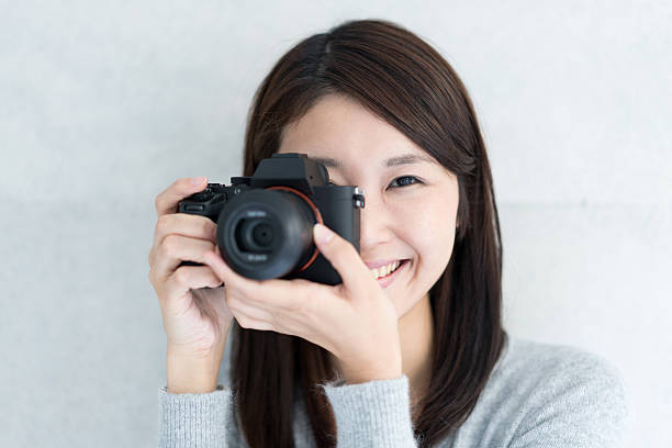 istock Asian young woman taking a picture 609443672