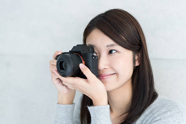 istock Asian young woman taking a picture 609443714