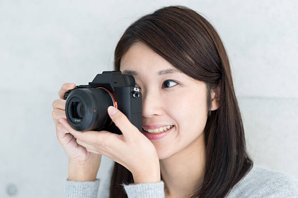 istock Asian young woman taking a picture 609443746