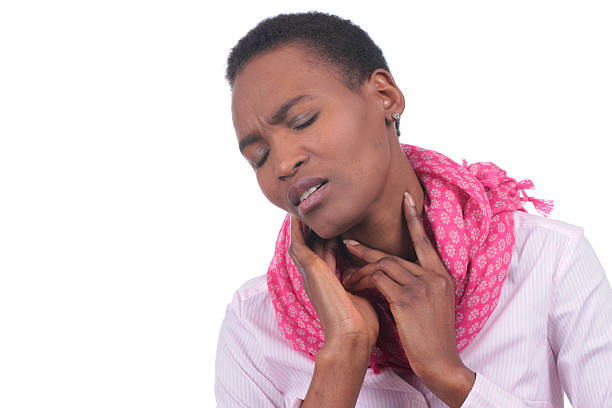istock African woman with sore throat 609443814