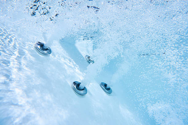 massage jets of whirlpool in action under water view of massage nozzles in outdoor hot tub hot tub stock pictures, royalty-free photos & images