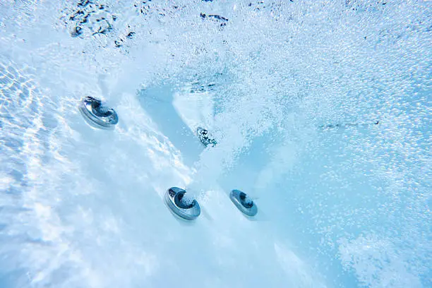 under water view of massage nozzles in outdoor hot tub