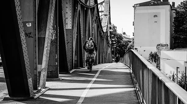 istock Man Cycling On Bridge In City 609445093