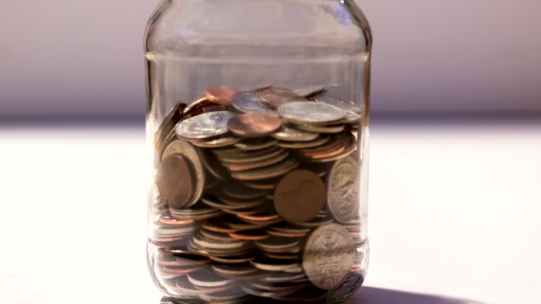 Saving Jar of Money Filling Up with Coins