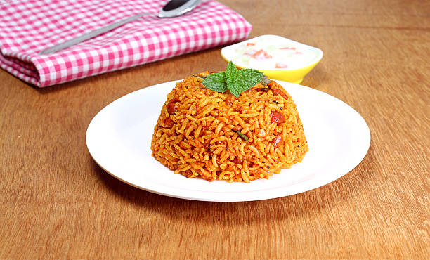 Indian Food Rice Pilaf Indian homemade traditional food rice pilaf on a plate. tomato rice stock pictures, royalty-free photos & images