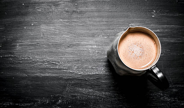istock pitcher of hot chocolate. On black rustic background. 609619606