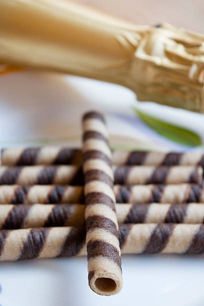 istock rolled wafers and champagne bottle 609620156