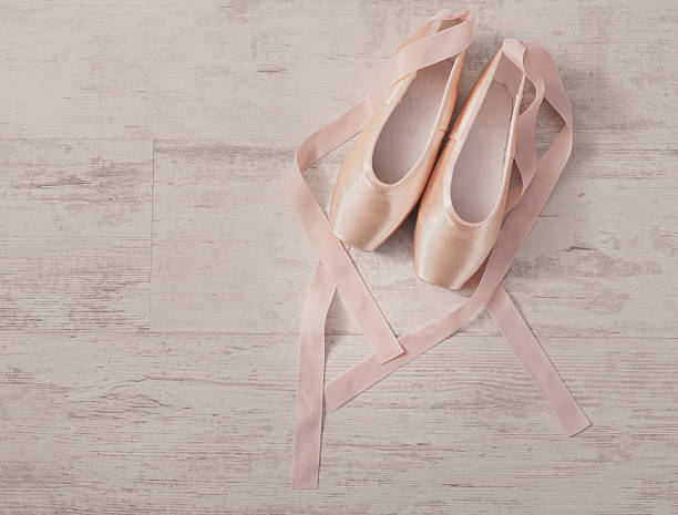 istock Pink ballet pointe shoes on white wood background 609624204