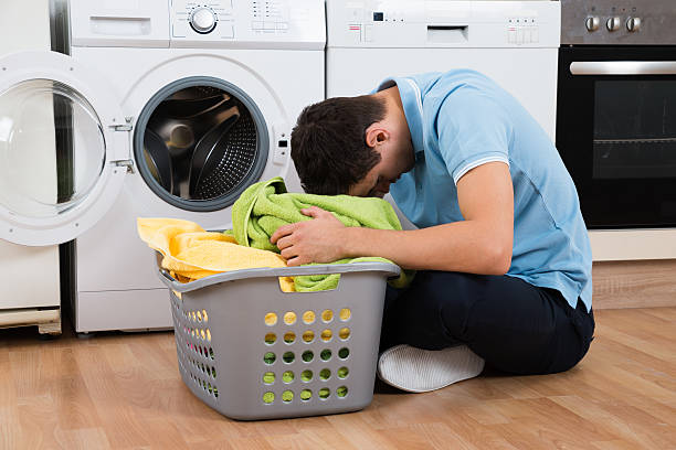 istock Exhausted Man With Laundry Basket Sitting By Washing Machine 609626966
