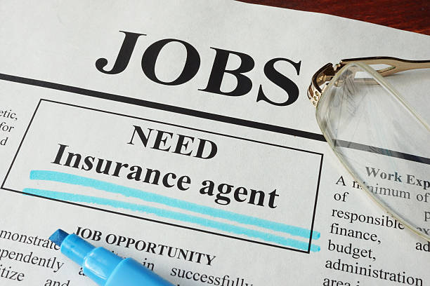 istock Newspaper with ads for vacancy Insurance agent. 609682824