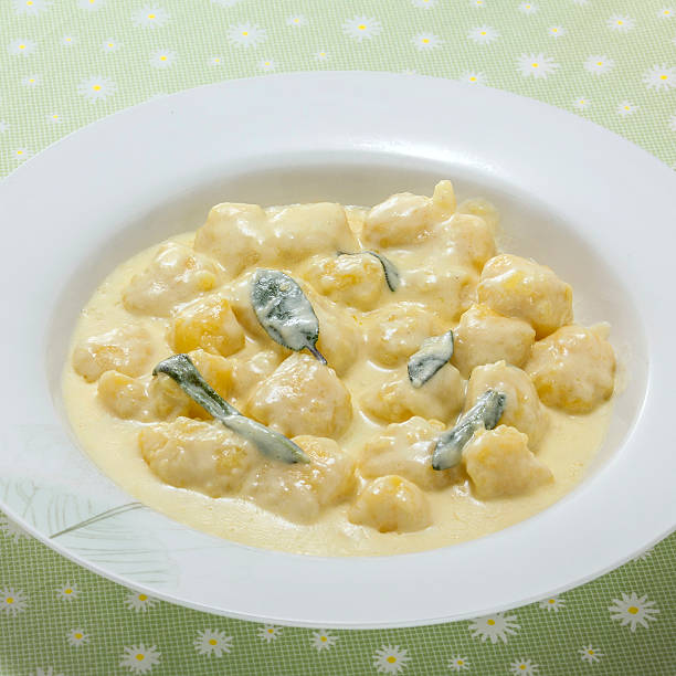 istock Creamy sweet potatoes soup with curry leaf on white platter 609684566
