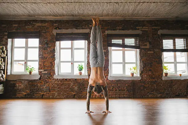 Young Caucasian man doing yoga in studio 