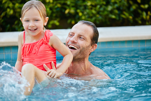Cropped shot of a father and daughter swimming in a pool together