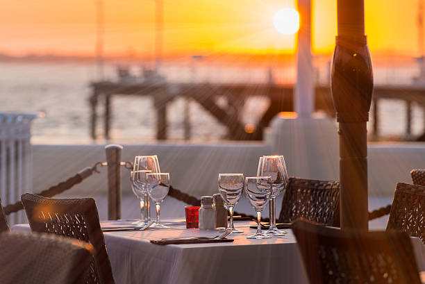 Outdoor place setting Close-up of outdoor place setting during sunset at waterfront promenade stock pictures, royalty-free photos & images