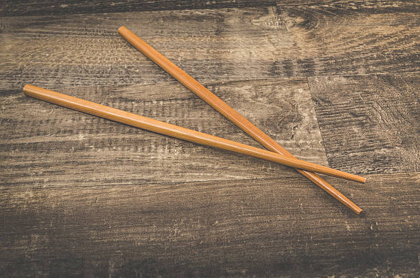 istock Asian chopsticks on wooden table 609687400