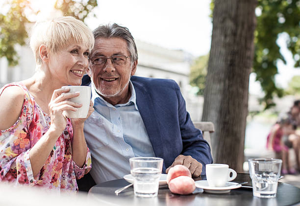 istock Senior Couple Drinking Coffe and Chatting at a Sidewalk Cafe 609688692