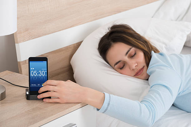 istock Woman Snoozing Alarm On Mobile Phone 609689028