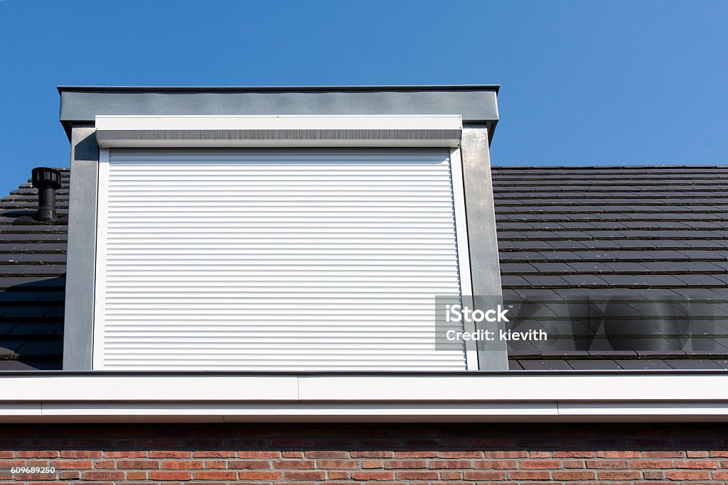 Dormer window with rolling safety  shutter Dormer window with rolling safety  shutter in the Netherlands Rolling Stock Photo